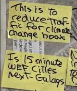 sticky notes that say "this is to reduce traffic for climate change hoax" and "is 15 minute WEF cities next - gulags"