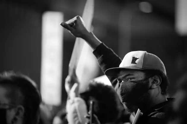 Man in Minnesota raises his fist at a protest