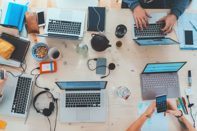 Diverse set of laptops on coffee shop table