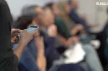 Person texting in front of crowd