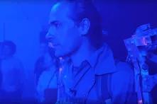 Reporter Felix Franz stands in an exoskeleton as part of an art exhibition