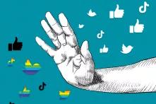 Hand blocks rainbow and black social media symbols