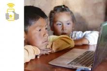 Two children in front of a laptop