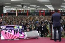 A man speaking in front of a crowd in Brazil
