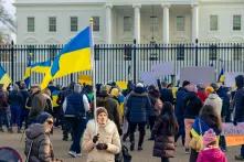 Woman holds Ukrainian flag in front of White House