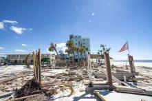 An American flag waves over destruction left by Hurricane Ian in Florida