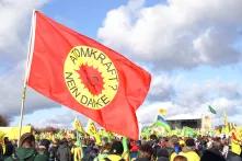 flag saying "atomic energy? no thanks" in front of a big rally
