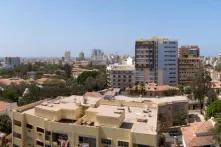 urban apartments and high rises with an ocean in the left background
