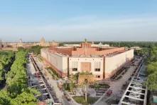 parliament of india with trees around it