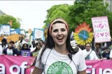 woman leading a protest with a banner behind her