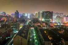 city at nighttime with large amounts of lights and highrises in the background