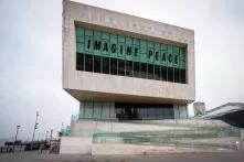 building with large sign that says "imagine peace"