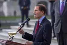 Older man speaking at podium