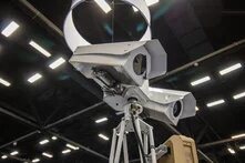 two surveillance cameras on a stand in an exposition hall