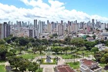 a large green, tropical park surrounded by tall buildings in Belém