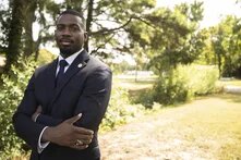 KeShaun Pearson in a suit outside on a sunny day