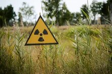 a nuclear sign outside a field of grass