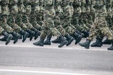 marching camoflauged people from the waist down