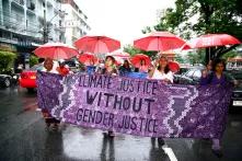 Women protesting with a sign that says "no climate justice without gender justice"