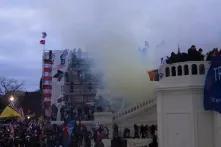far right protesters storming over stairs in front of the US Capitol on January 6, 2021