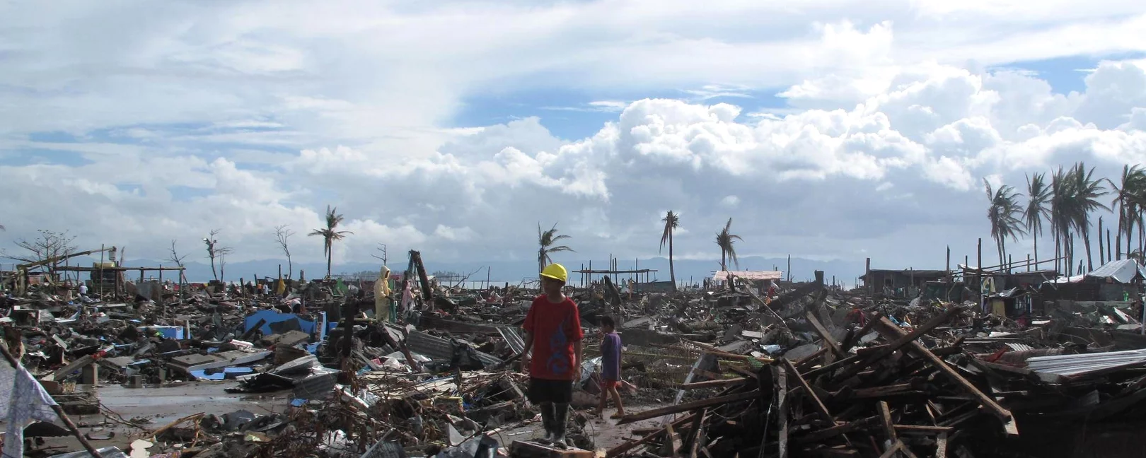 A man stands surrounded by the devastation wrought by Typhoon Haiyan in the city of Tacloban