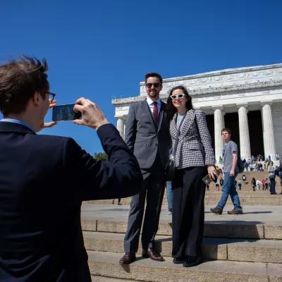 The participants of the Study Tour are taking photos in front of the Lincoln Memorial.