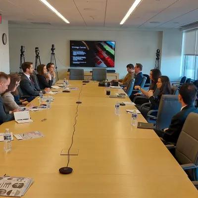 The participants of the Study Tour are attending a briefing on wargaming in a CNAS conference room.