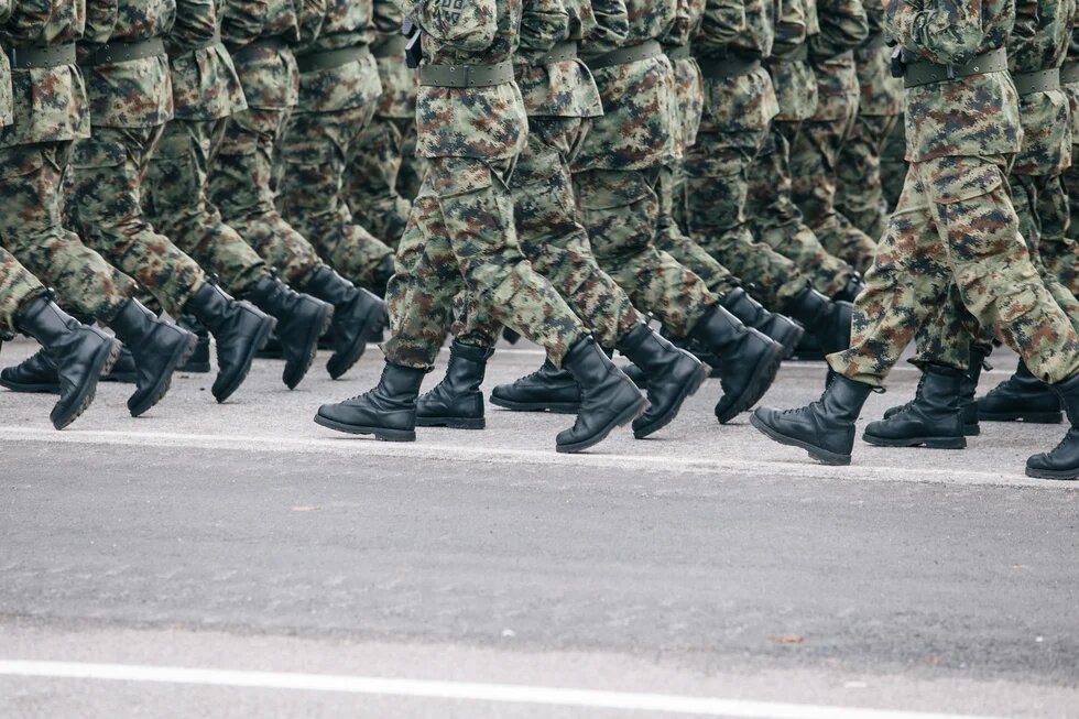 marching camoflauged people from the waist down