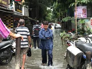 Man stands in flooded street