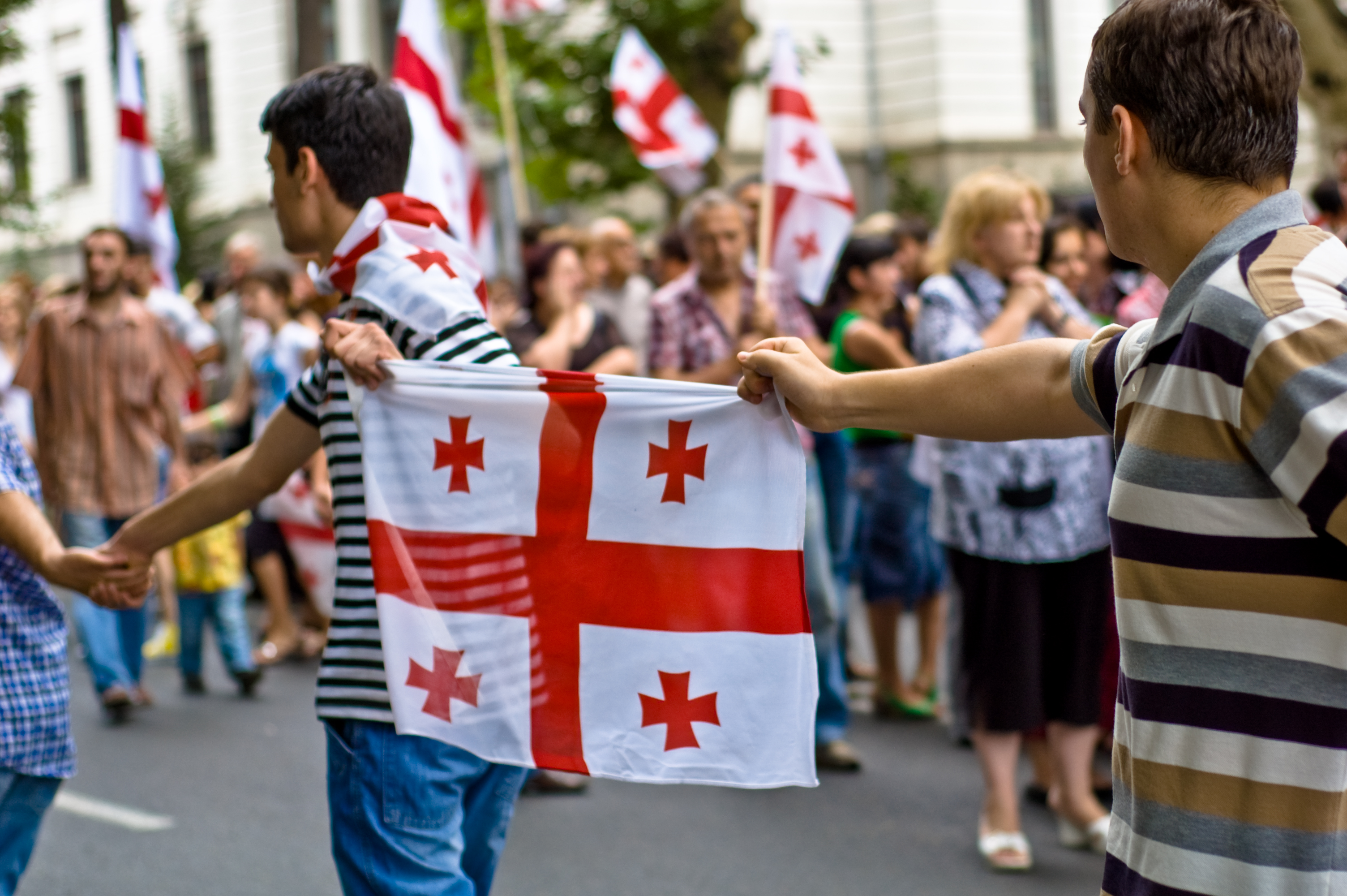 Protesters hold a Georgian flag